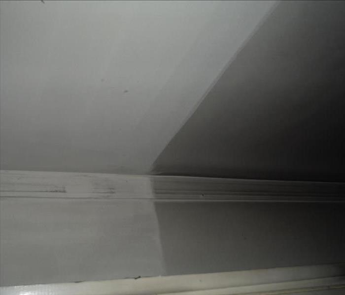 Wall and ceiling in Manchester, NJ in the process of SEVPRO of Lacey, Manchester removing soot damage from it